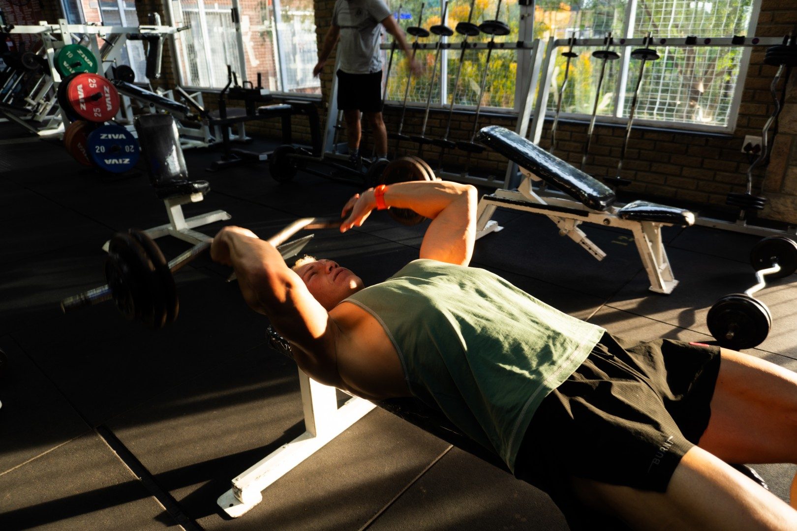 Gym member doing dumbbell incline press at Oxigim