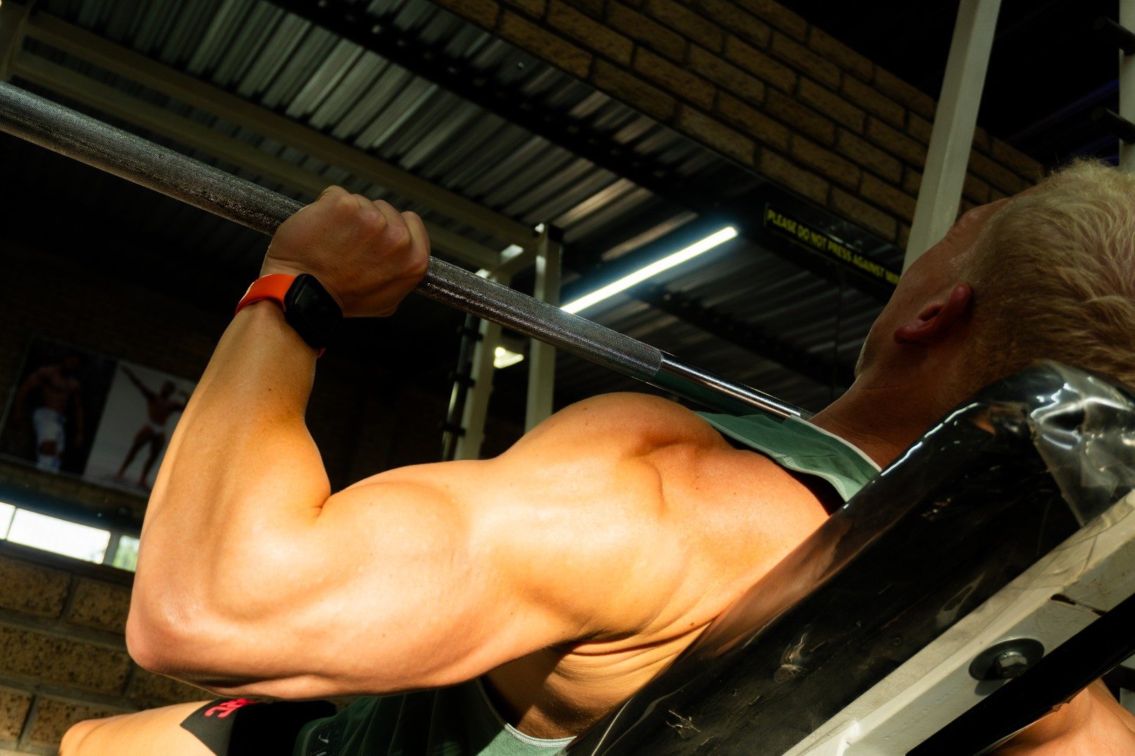 Gym member performing incline barbell press