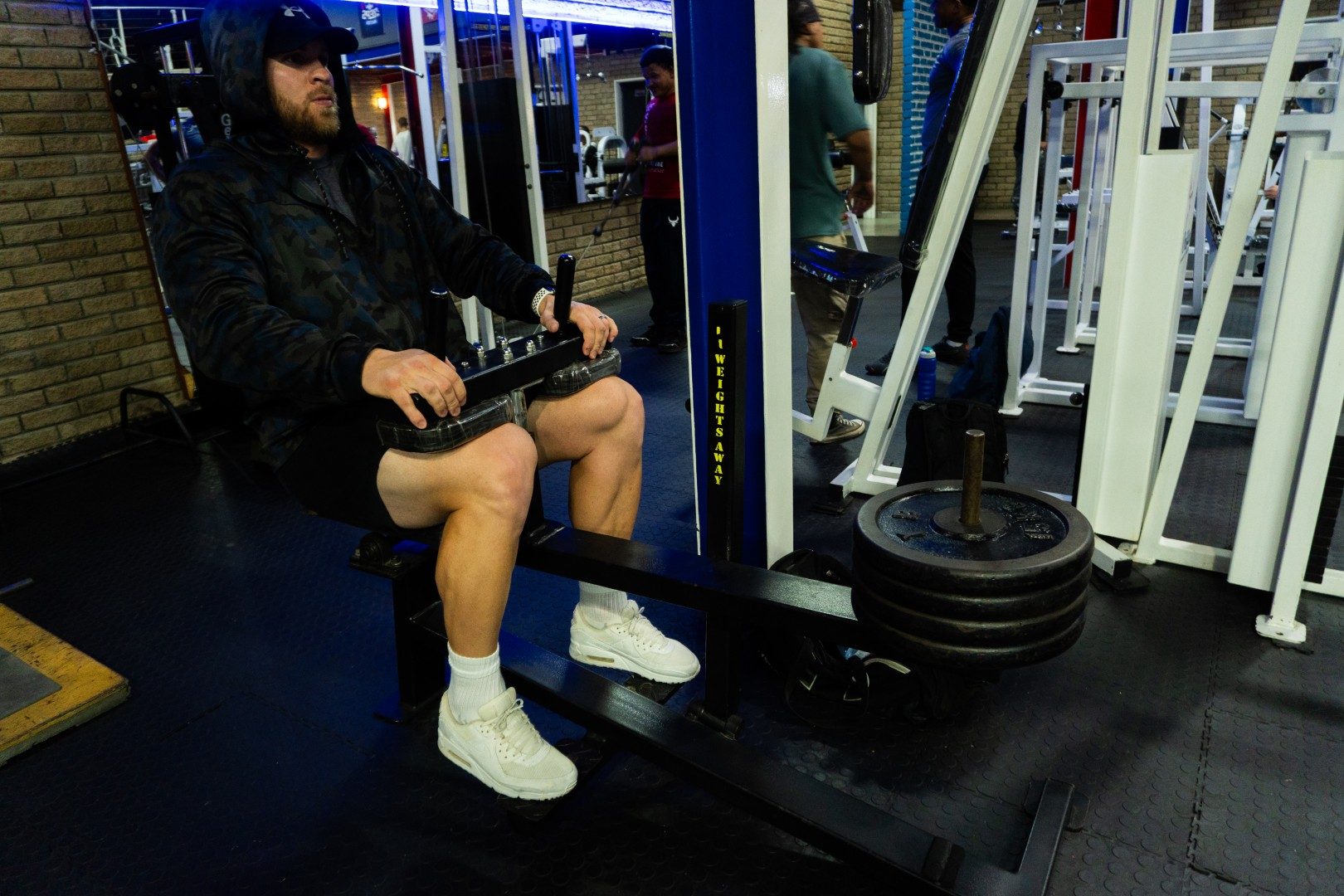 Gym member on seated calf machine at Oxigim